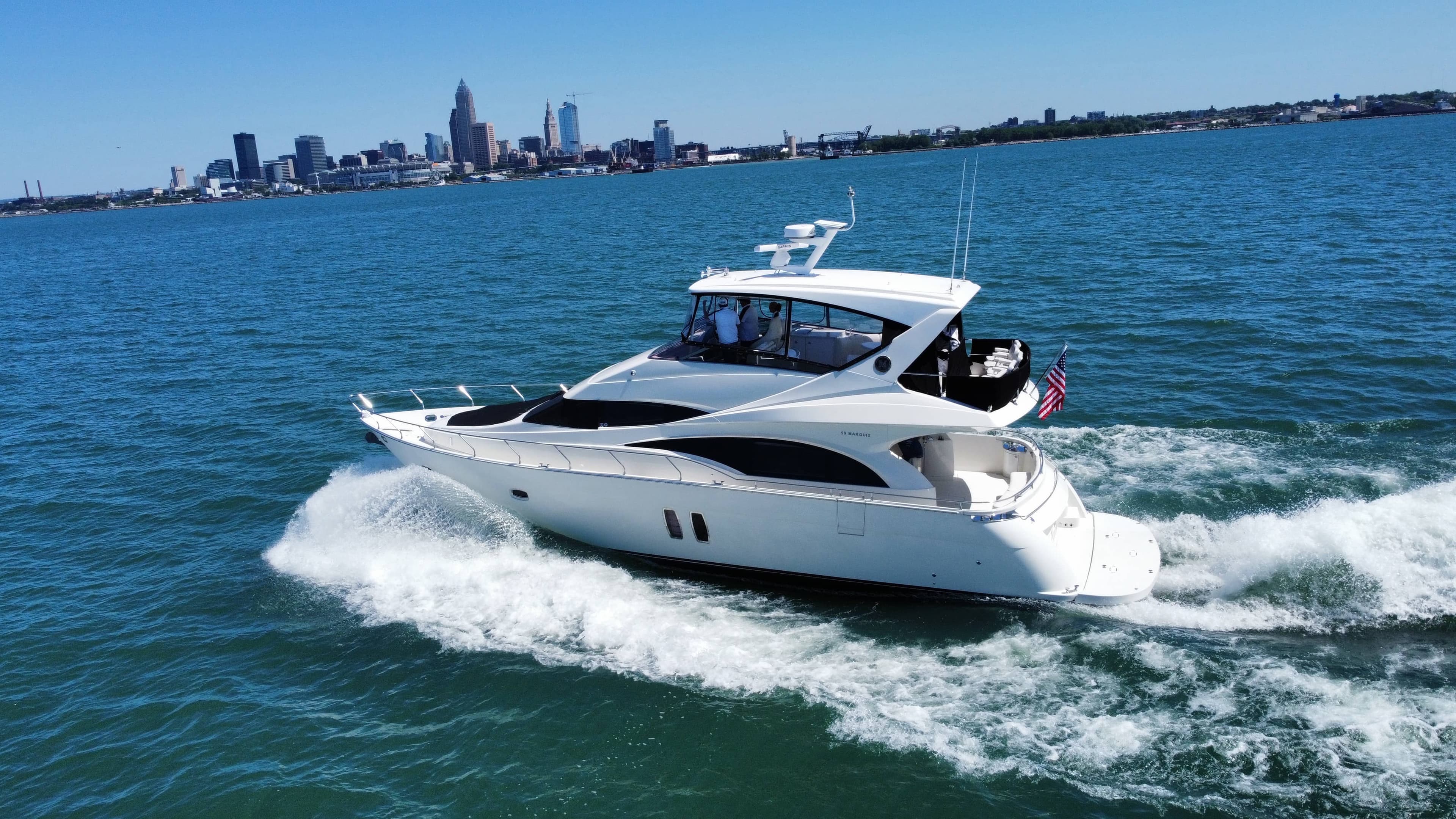 Cabin cruiser underway on Lake Erie off Cleveland's lakefront, the kind of boat we help buyers find