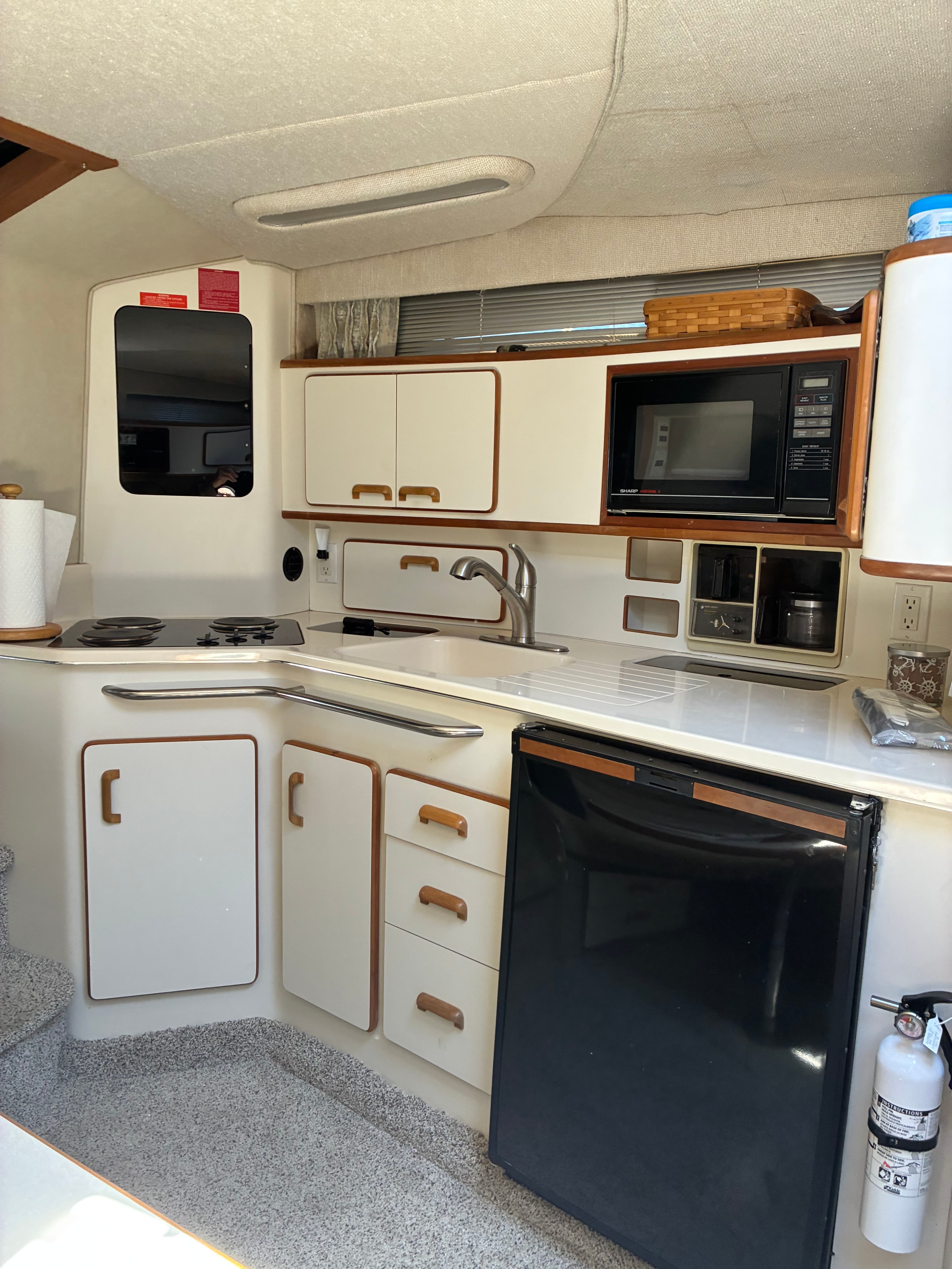 1990 Sea Ray 350 Express Cruiser galley microwave and storage detail