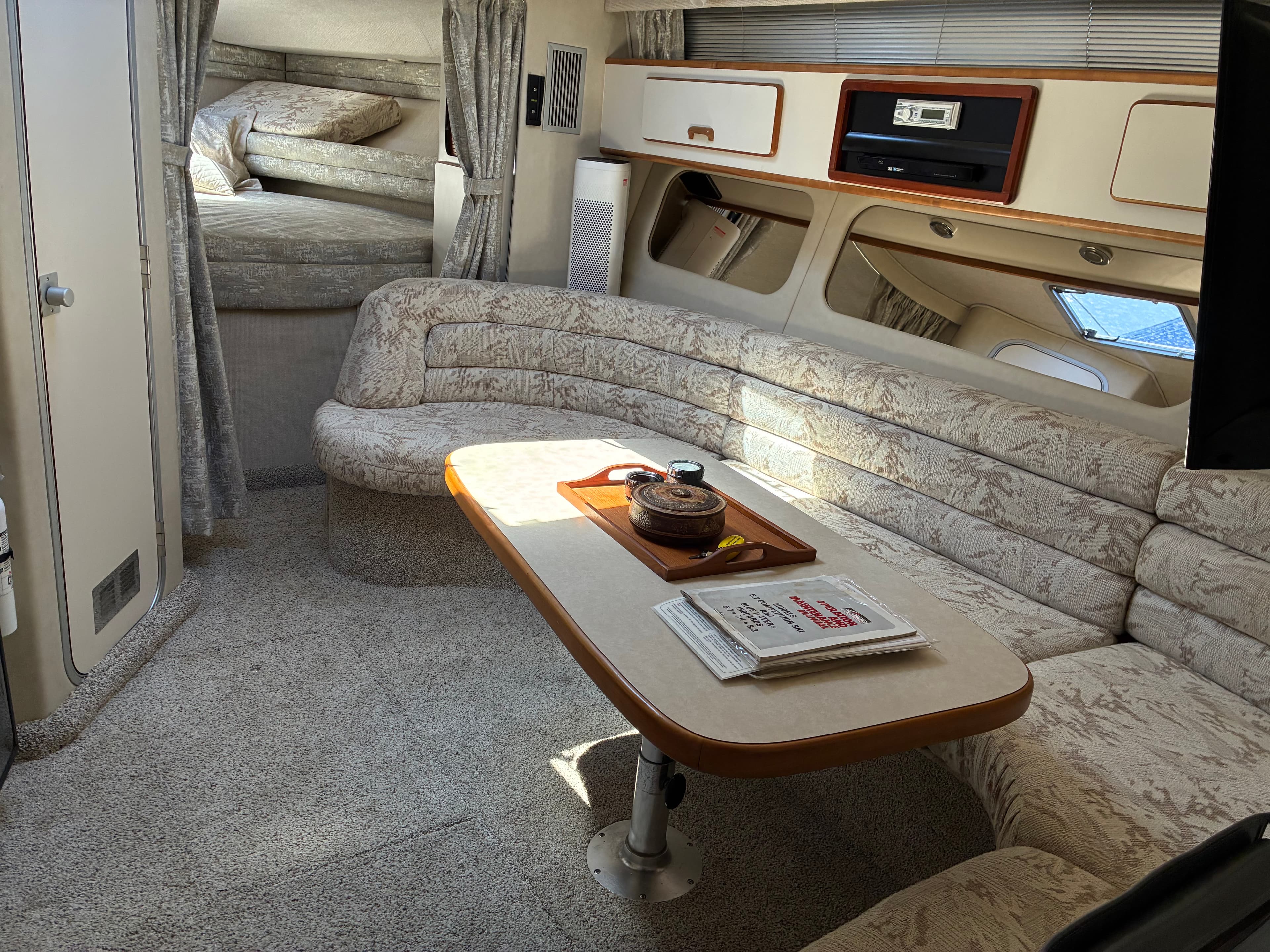 1990 Sea Ray 350 Express Cruiser mid-cabin berth with privacy curtains