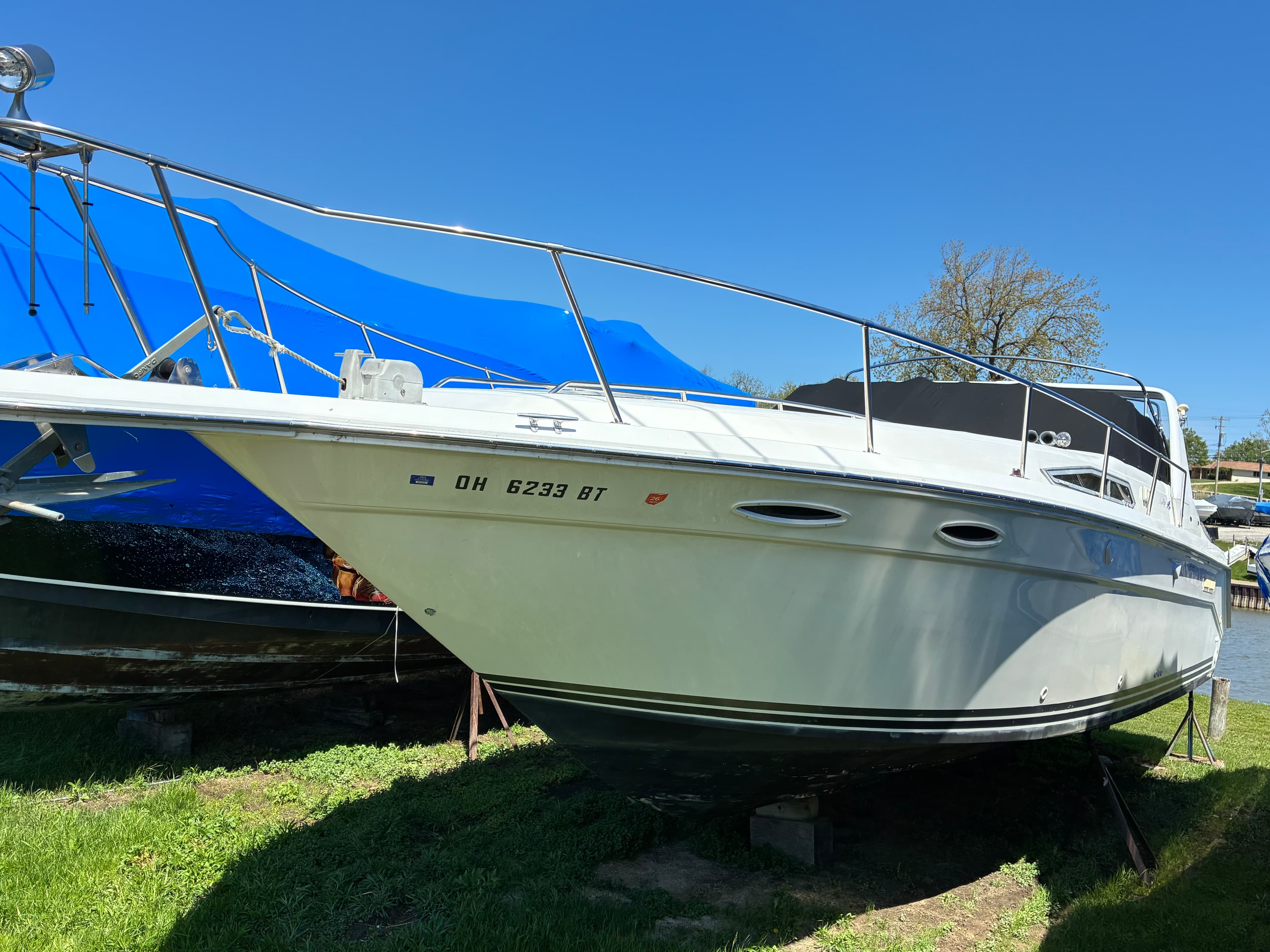 1990 Sea Ray 350 Express Cruiser port side profile on stands at Chagrin River, Ohio