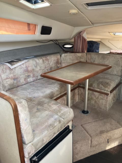 1994 Bayliner 3055 cabin dinette with fabric upholstery and wood trim