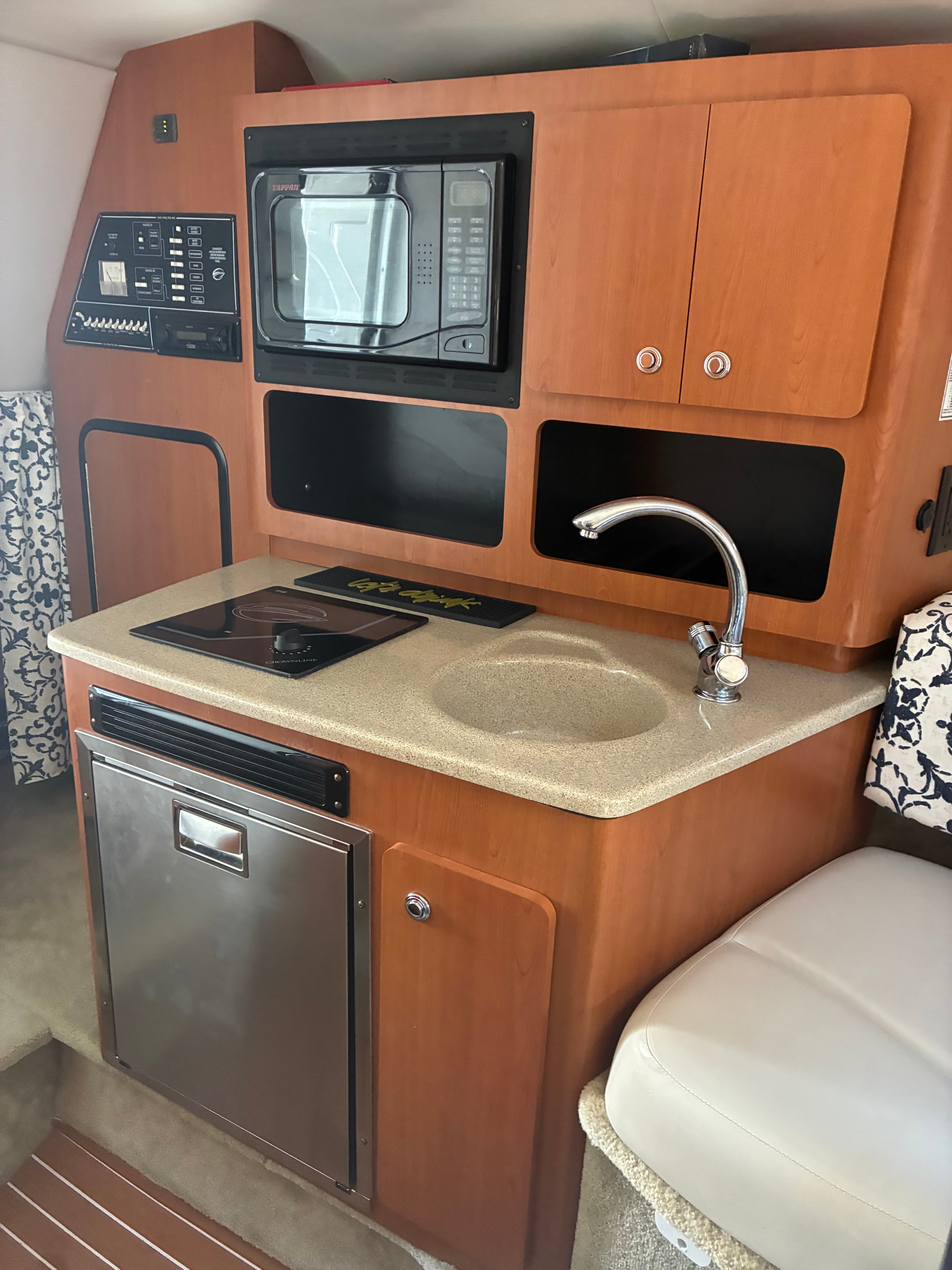 2005 Crownline 270CR galley with Corian countertop and stainless refrigerator