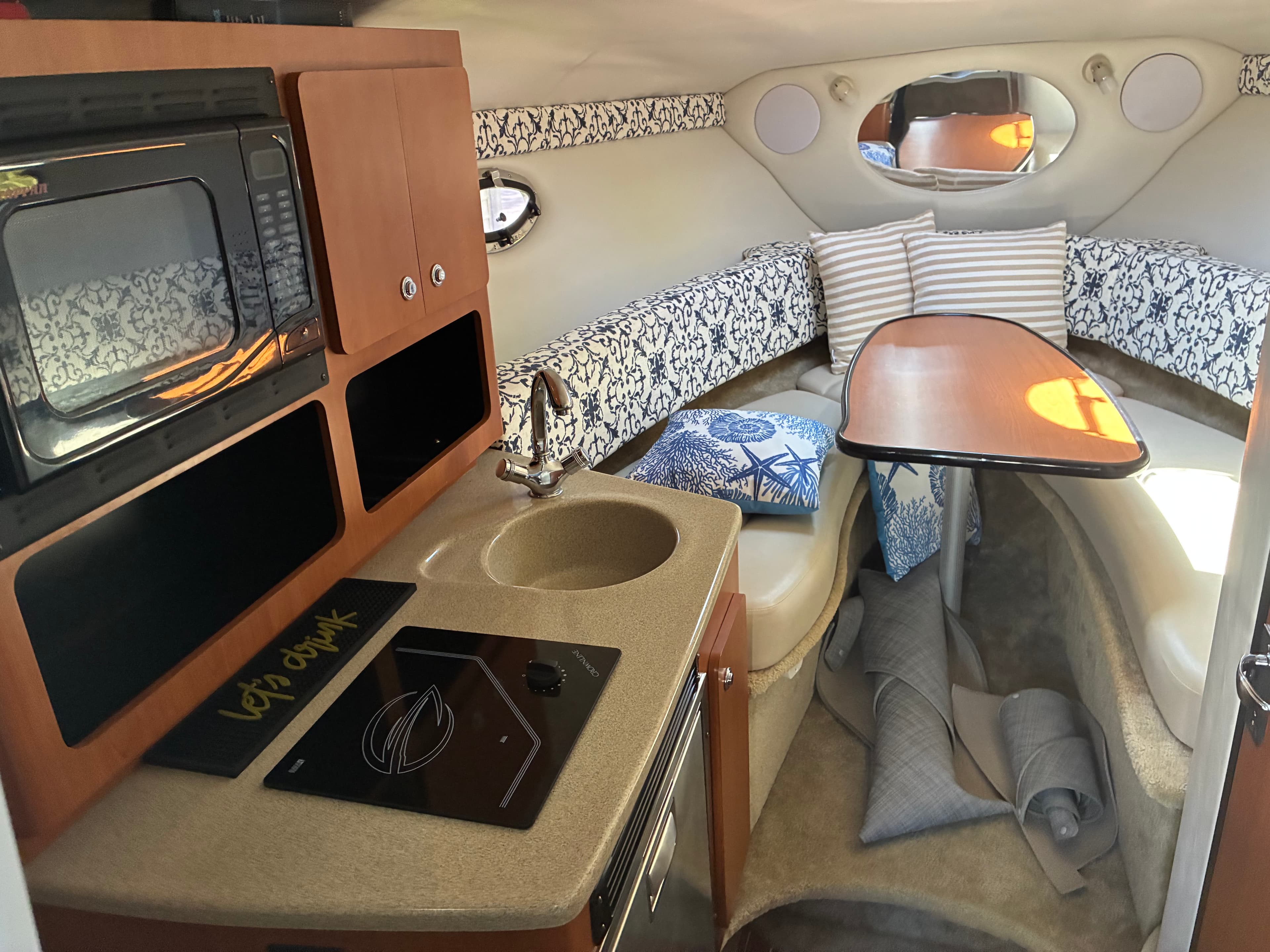 2005 Crownline 270CR galley with one-burner stove, sink and dinette